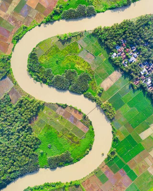 aerial photogrpah of a river and plots of farmland.